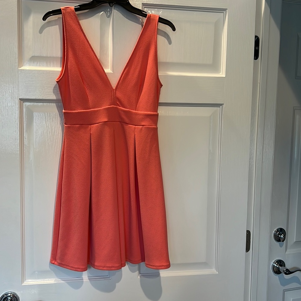 Salmon/peach color dress in a stretchy material.
